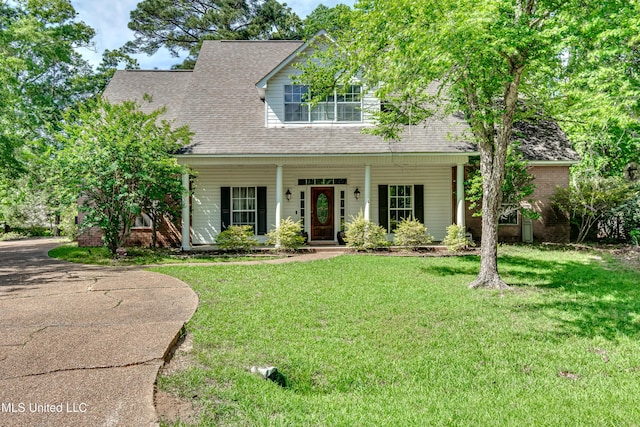 view of front of home featuring roof with shingles, a porch, and a front lawn