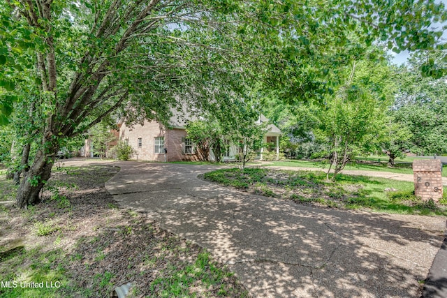 obstructed view of property with brick siding