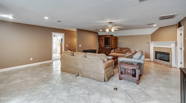 living room with a ceiling fan, visible vents, a high end fireplace, light tile patterned floors, and recessed lighting