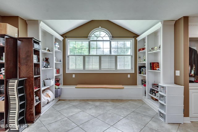 interior space featuring vaulted ceiling and light tile patterned floors