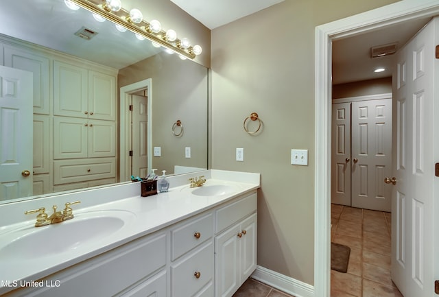 full bath featuring visible vents, a sink, baseboards, and tile patterned floors