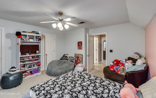 carpeted bedroom with vaulted ceiling, a ceiling fan, and visible vents