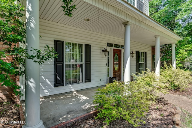 view of exterior entry with a porch