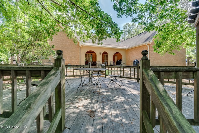 wooden terrace featuring outdoor dining area