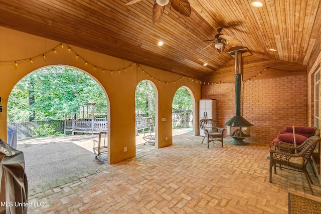 view of patio with ceiling fan and fence