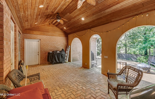 view of patio / terrace with fence and a ceiling fan