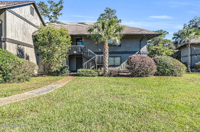 back of property featuring a lawn