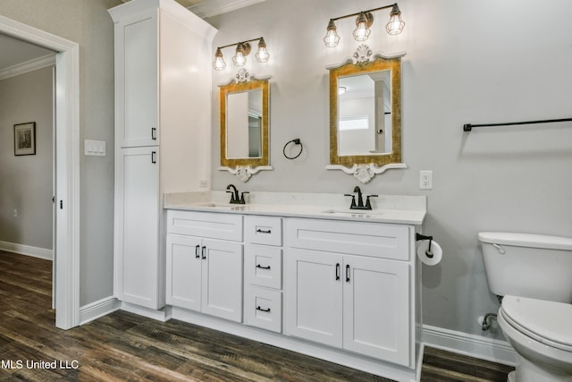 bathroom with ornamental molding, hardwood / wood-style flooring, and toilet