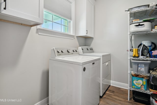 laundry area featuring cabinets, independent washer and dryer, and dark hardwood / wood-style flooring