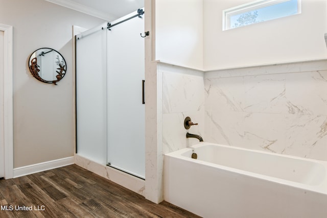 bathroom featuring crown molding, wood-type flooring, and separate shower and tub