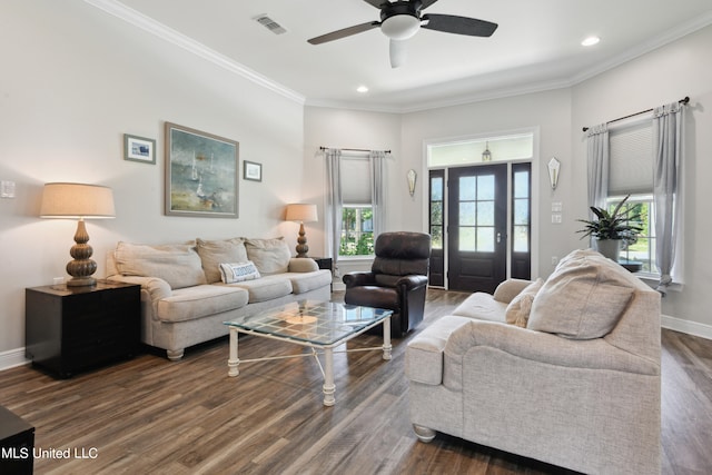 living room with crown molding, dark hardwood / wood-style floors, and ceiling fan