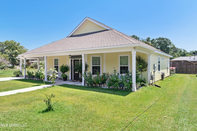 farmhouse-style home featuring covered porch and a front yard