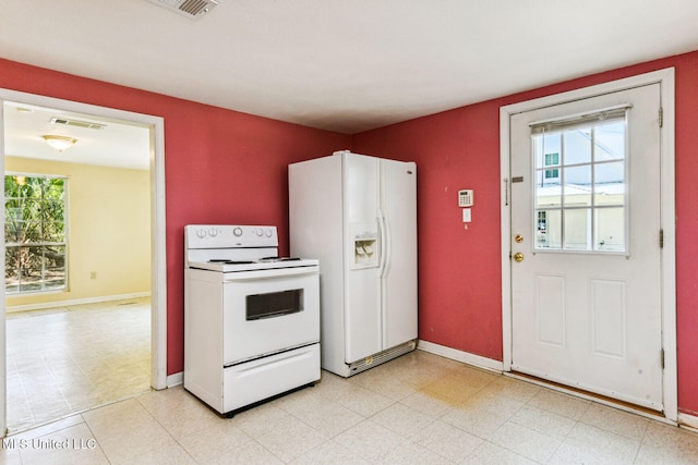 kitchen with white appliances and a wealth of natural light