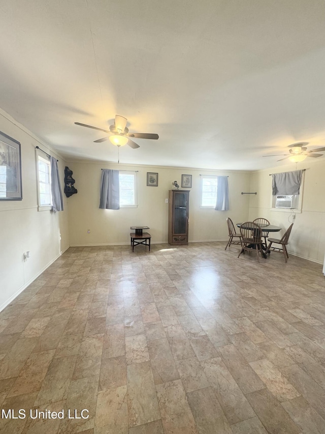 empty room featuring ceiling fan and cooling unit