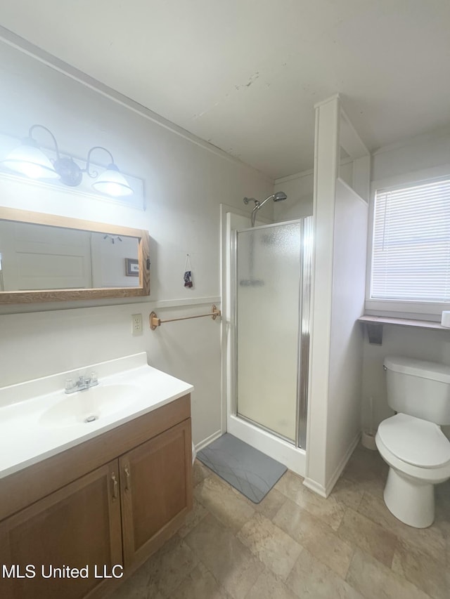 bathroom with vanity, toilet, and an enclosed shower