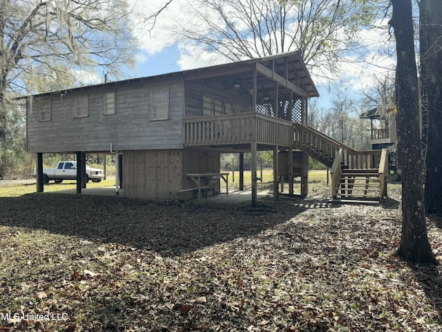 rear view of property with a carport