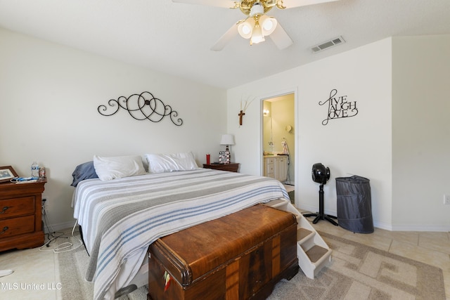 bedroom featuring a ceiling fan, baseboards, visible vents, and ensuite bath