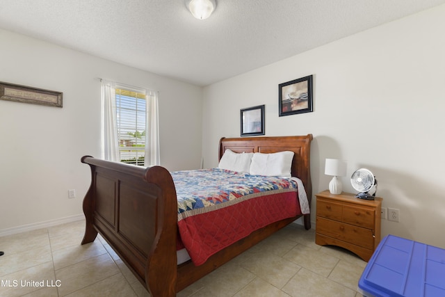 bedroom featuring baseboards and light tile patterned flooring