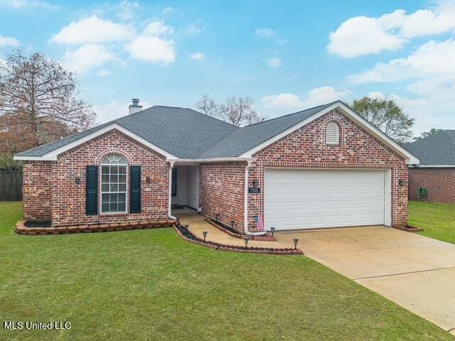 single story home with a garage and a front lawn