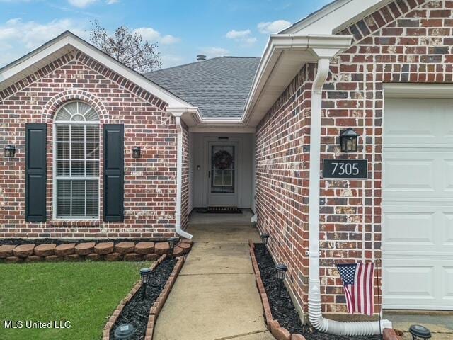 doorway to property with a garage