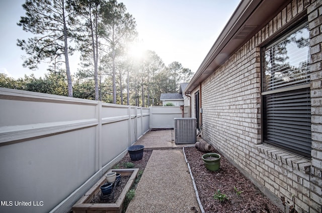 view of side of property featuring central air condition unit