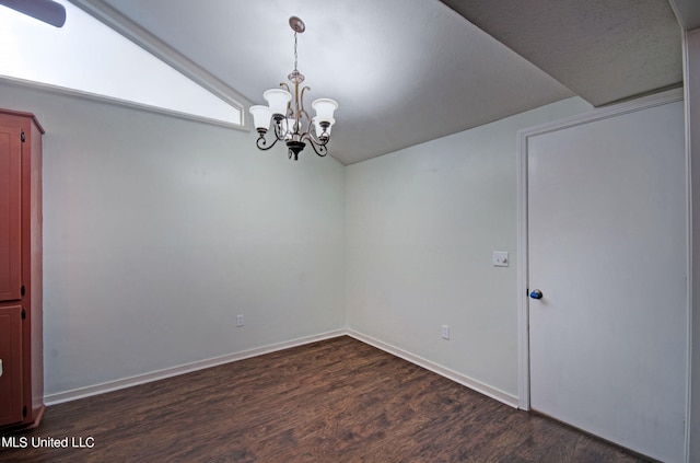 spare room with lofted ceiling, a chandelier, and dark hardwood / wood-style flooring