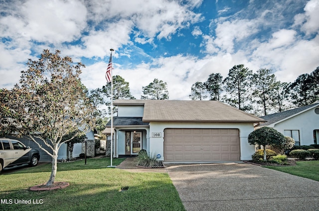 view of front of home featuring a front lawn and a garage