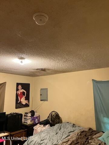 1710 Eastward Dr, Gulfport, MS 39501 - bedroom with a textured ceiling and electric panel