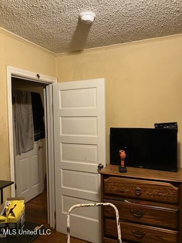 1710 Eastward Dr, Gulfport, MS 39501 - bedroom with a textured ceiling, ornamental molding, and wood finished floors