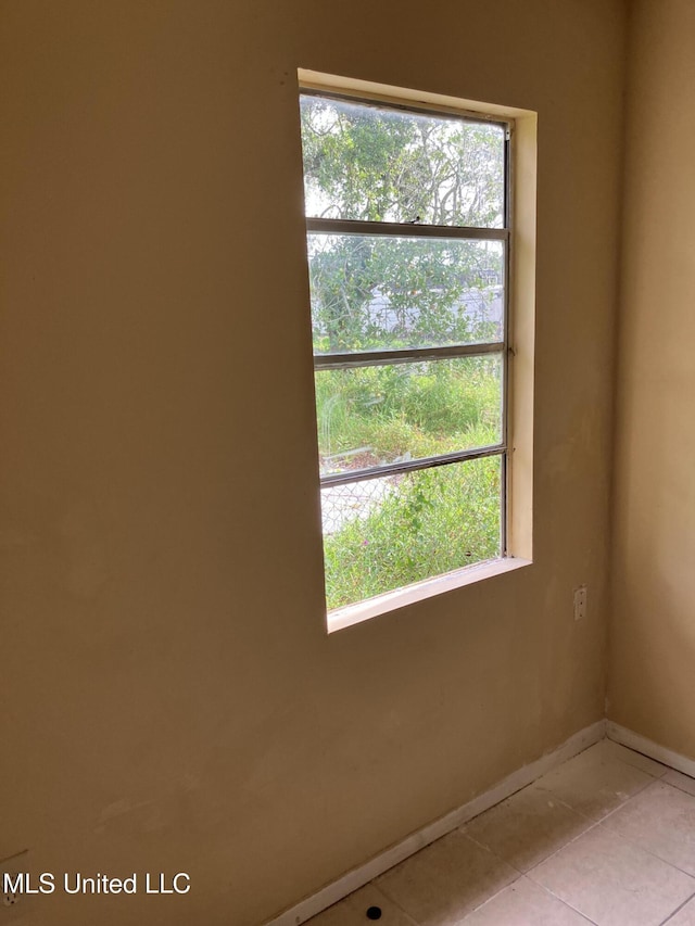 1710 Eastward Dr, Gulfport, MS 39501 - spare room featuring healthy amount of natural light, baseboards, and light tile patterned flooring