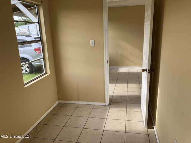 1710 Eastward Dr, Gulfport, MS 39501 - hallway with light tile patterned flooring, baseboards, and plenty of natural light