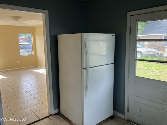 1710 Eastward Dr, Gulfport, MS 39501 - kitchen with freestanding refrigerator, healthy amount of natural light, and light tile patterned flooring