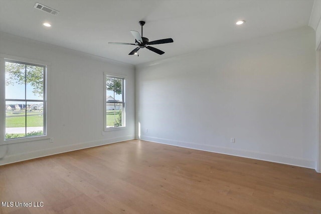 spare room featuring light hardwood / wood-style flooring, ornamental molding, and ceiling fan