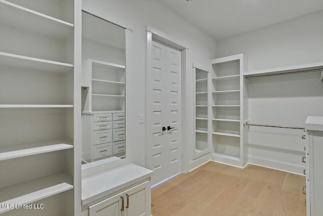 spacious closet featuring light hardwood / wood-style floors