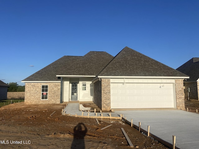 422 Baleigh Way, Canton, MS 39046 - view of front of home featuring brick siding, driveway, a garage, and a shingled roof