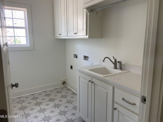 422 Baleigh Way, Canton, MS 39046 - washroom featuring washer hookup, electric dryer hookup, baseboards, light flooring, and cabinet space