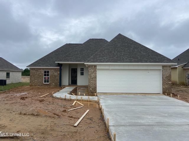 422 Baleigh Way, Canton, MS 39046 - view of front of house featuring brick siding, concrete driveway, and roof with shingles