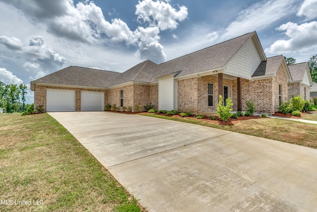 view of front of home with a garage, a front yard, and brick siding