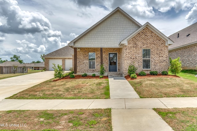 view of front of home with a garage, brick siding, driveway, and a front lawn