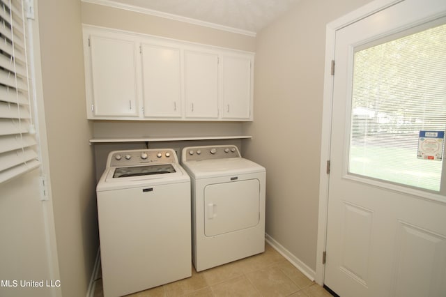 washroom featuring independent washer and dryer, ornamental molding, cabinets, and light tile patterned floors