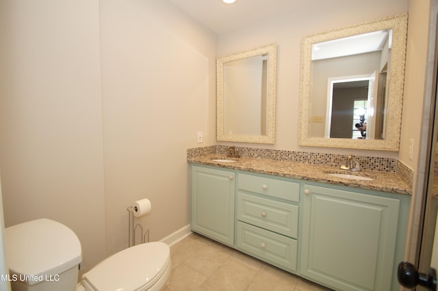 bathroom featuring toilet, vanity, and tile patterned flooring