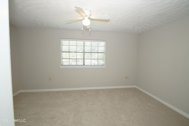 carpeted spare room with ceiling fan and a textured ceiling