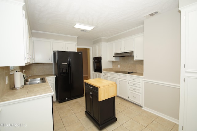 kitchen with decorative backsplash, a kitchen island, sink, black appliances, and white cabinetry