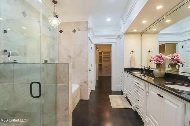 8521 Julia Dr, Vancleave, MS 39565 - bathroom featuring recessed lighting, a stall shower, a walk in closet, and a sink