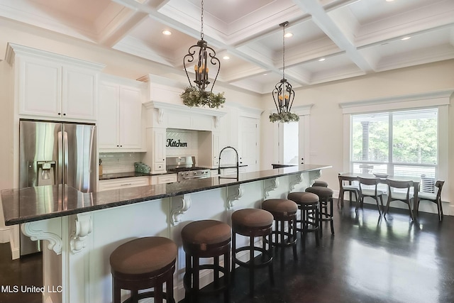 8521 Julia Dr, Vancleave, MS 39565 - kitchen featuring beamed ceiling, a kitchen bar, appliances with stainless steel finishes, and a spacious island