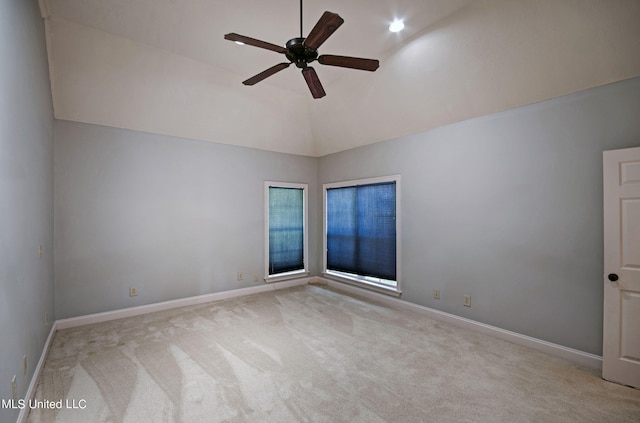 carpeted empty room featuring high vaulted ceiling and ceiling fan