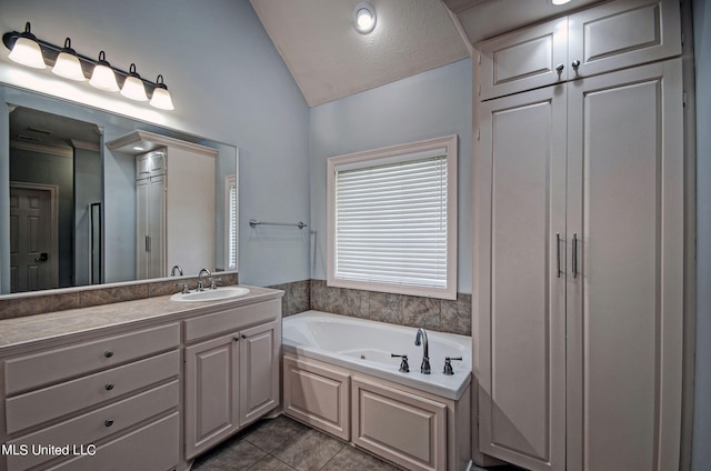 bathroom featuring vanity, vaulted ceiling, a bath, and tile patterned floors