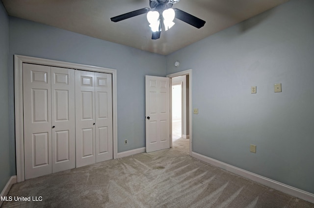 unfurnished bedroom with a closet, light colored carpet, and ceiling fan