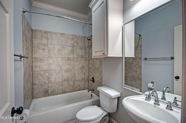 full bathroom with tiled shower / bath, sink, crown molding, and toilet