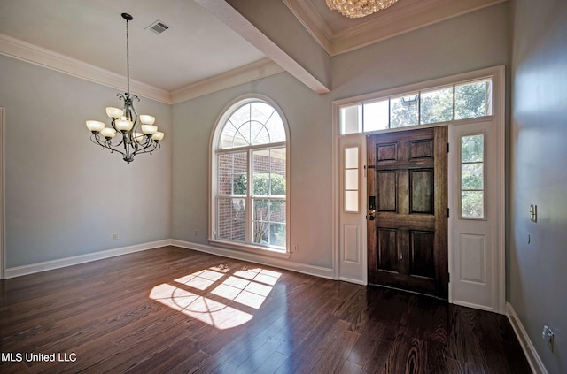 foyer entrance featuring ornamental molding, a chandelier, a healthy amount of sunlight, and dark hardwood / wood-style flooring